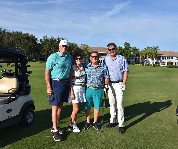 pairs of golfers by golf cart